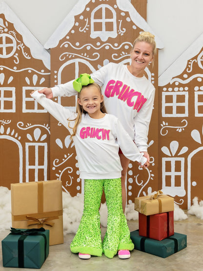 Mom and daughter wearing matching Grinchy chenille Christmas sweatshirts