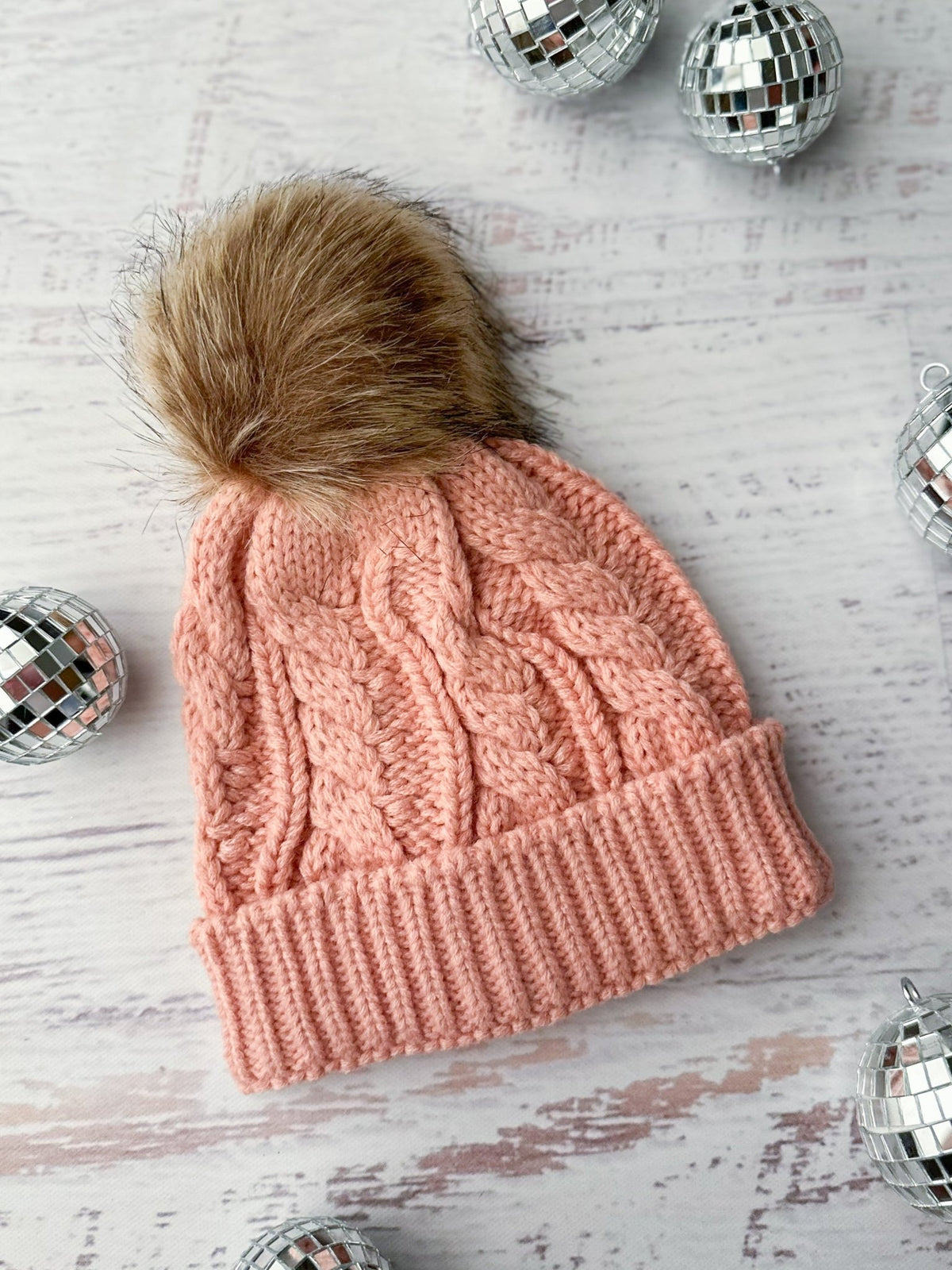 Girls light pink knit beanie with a brown fur pom