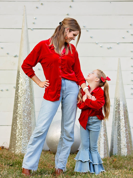 Mom and daughter in matching red velvet button-downs