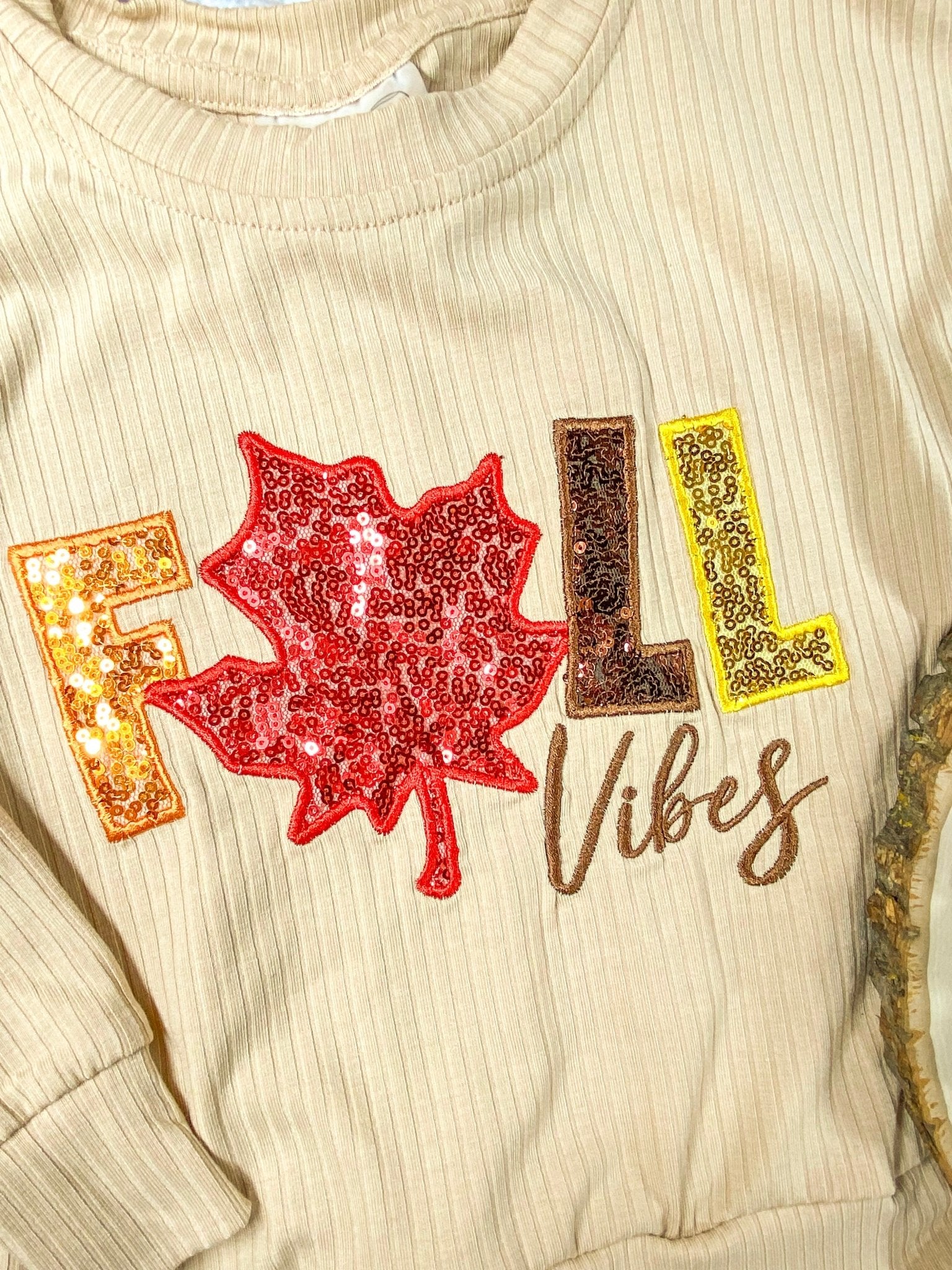 close up photo f "Fall Vibes" stitching and sequins on shirt