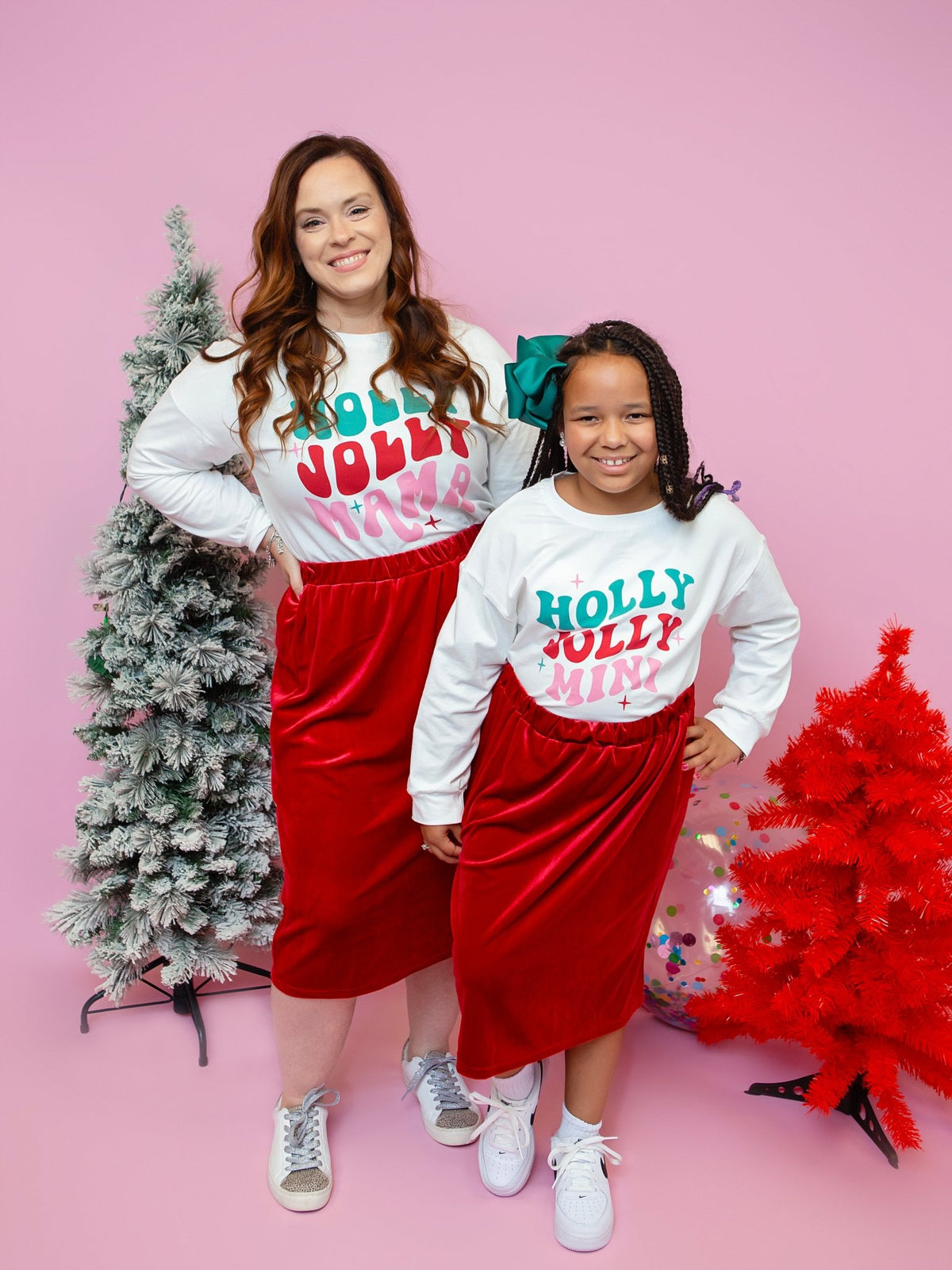 Mom and daughter in matching Holly Jolly tees