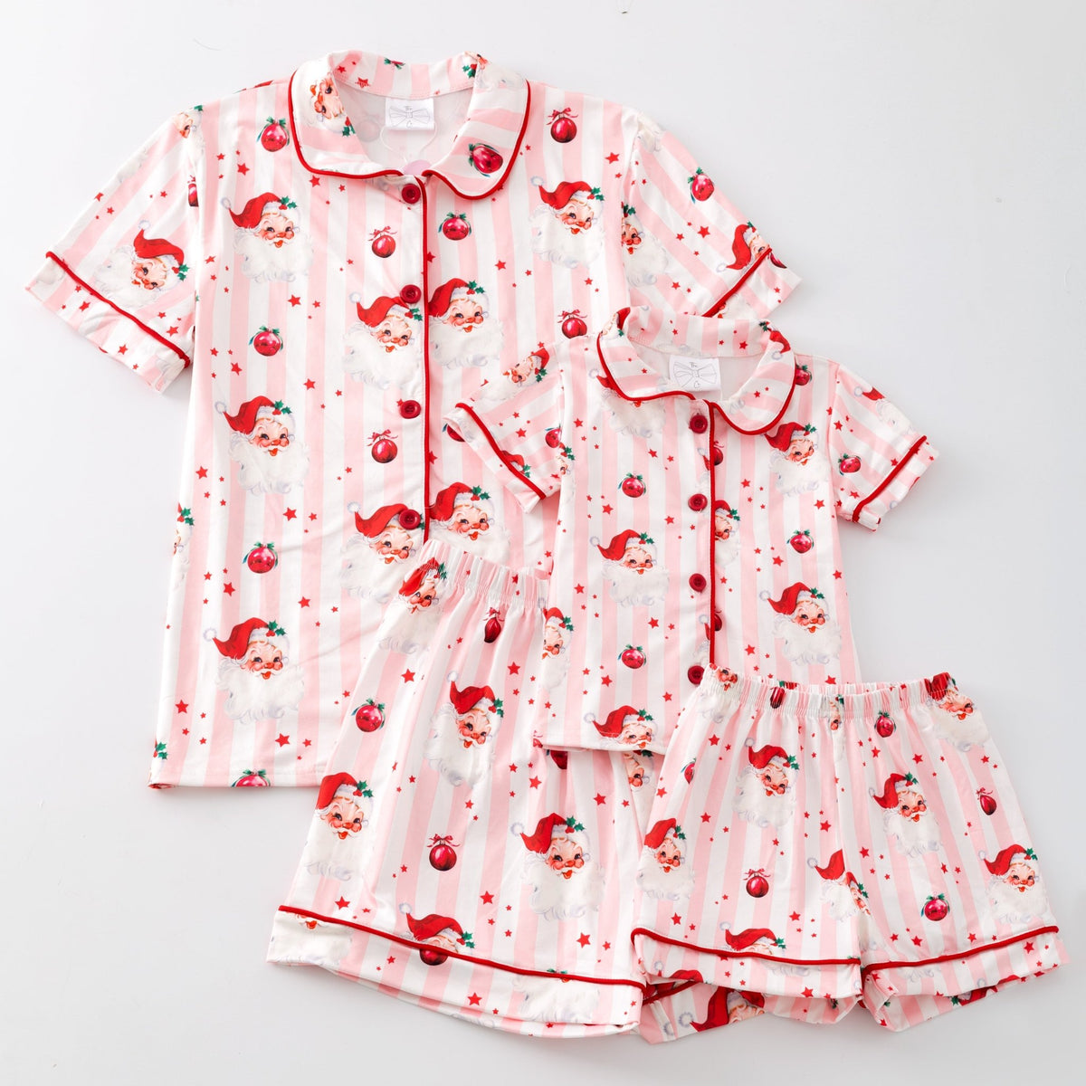 Pink Santa print Christmas pajama set laid flat