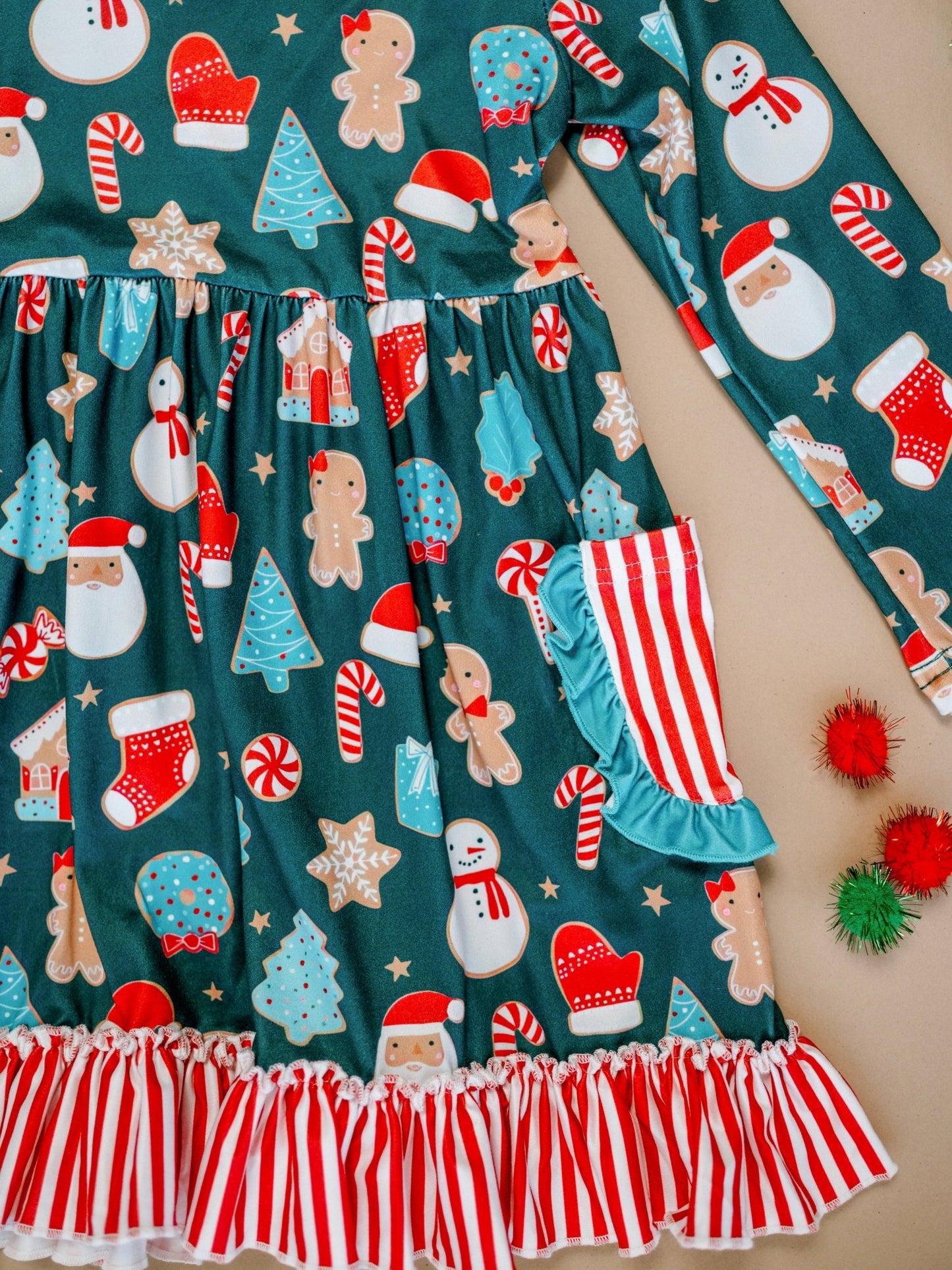 Children's outfit with Christmas-themed pattern on a teal background