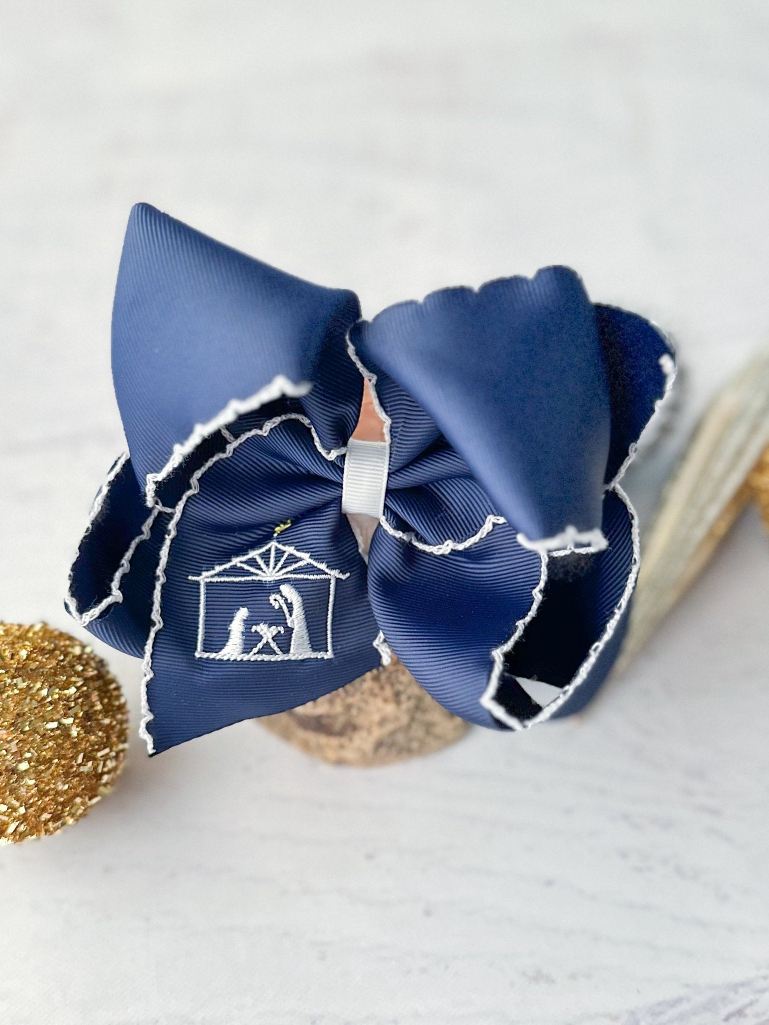 navy with white moonstitch hair bow with nativity embroidered
