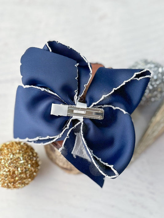 Navy blue hair bow with a silver clip on a light background - Alternative view