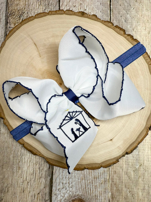 White and blue hair bow on a wooden surface