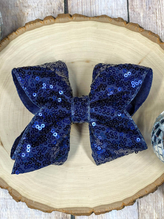navy Blue sequin bow on a wooden surface