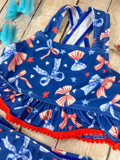  Patriotic Bow Print Ruffle Swim Set on a wooden background