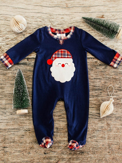 navy long sleeve infant boys romper flay lay showing a santa wearing a red, navy, and white plaid hat applique in center and same plaid details at collor, trim of sleeves, and footies 