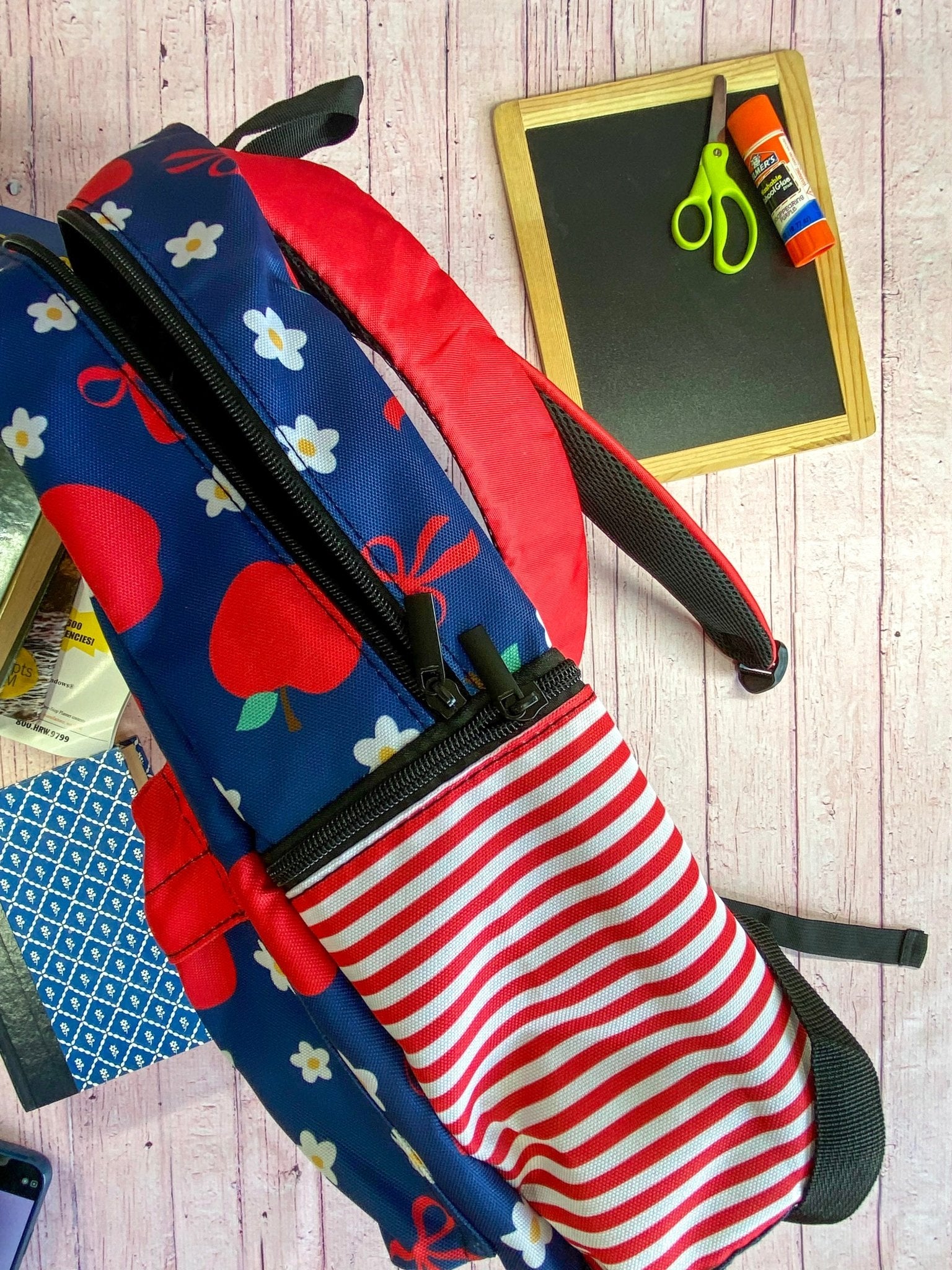 side of the Navy & Red Apples Backpack