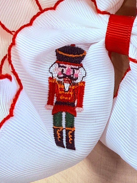 Close-up of nutcracker embroidery and moonstitch detail on hair bow - Alternative view
