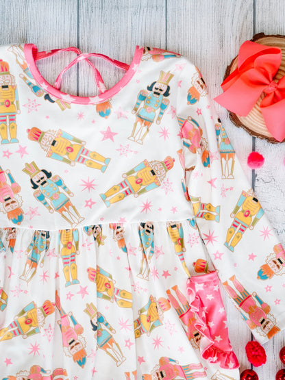 Children's dress with nutcracker pattern on a wooden surface