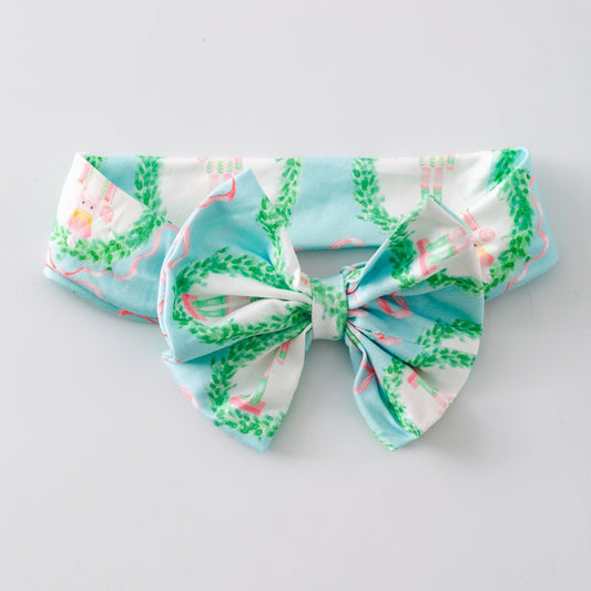 Large fabric bow with a nutcracker pattern on a light gray background - Alternative view