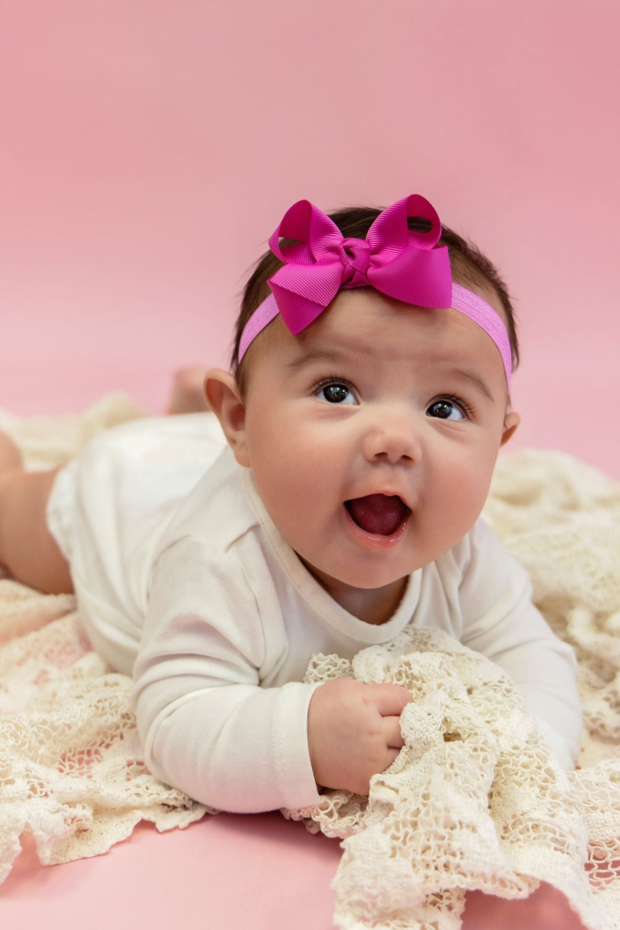 Baby wearing a 3-inch grosgrain hair bow on a soft headband