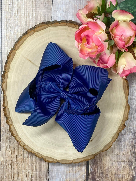 navy hair bow on wooden display