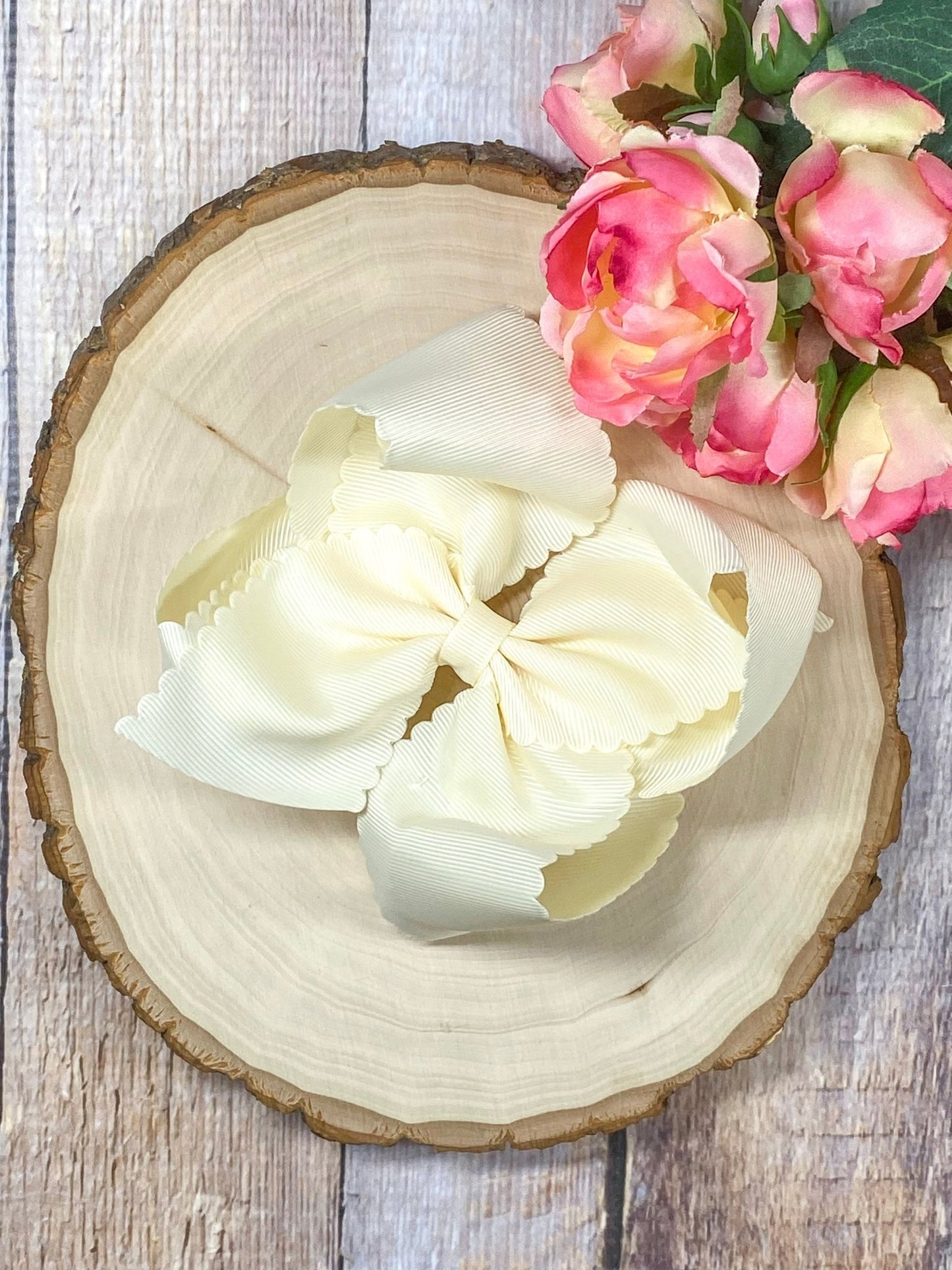 cream hair bow on wooden display