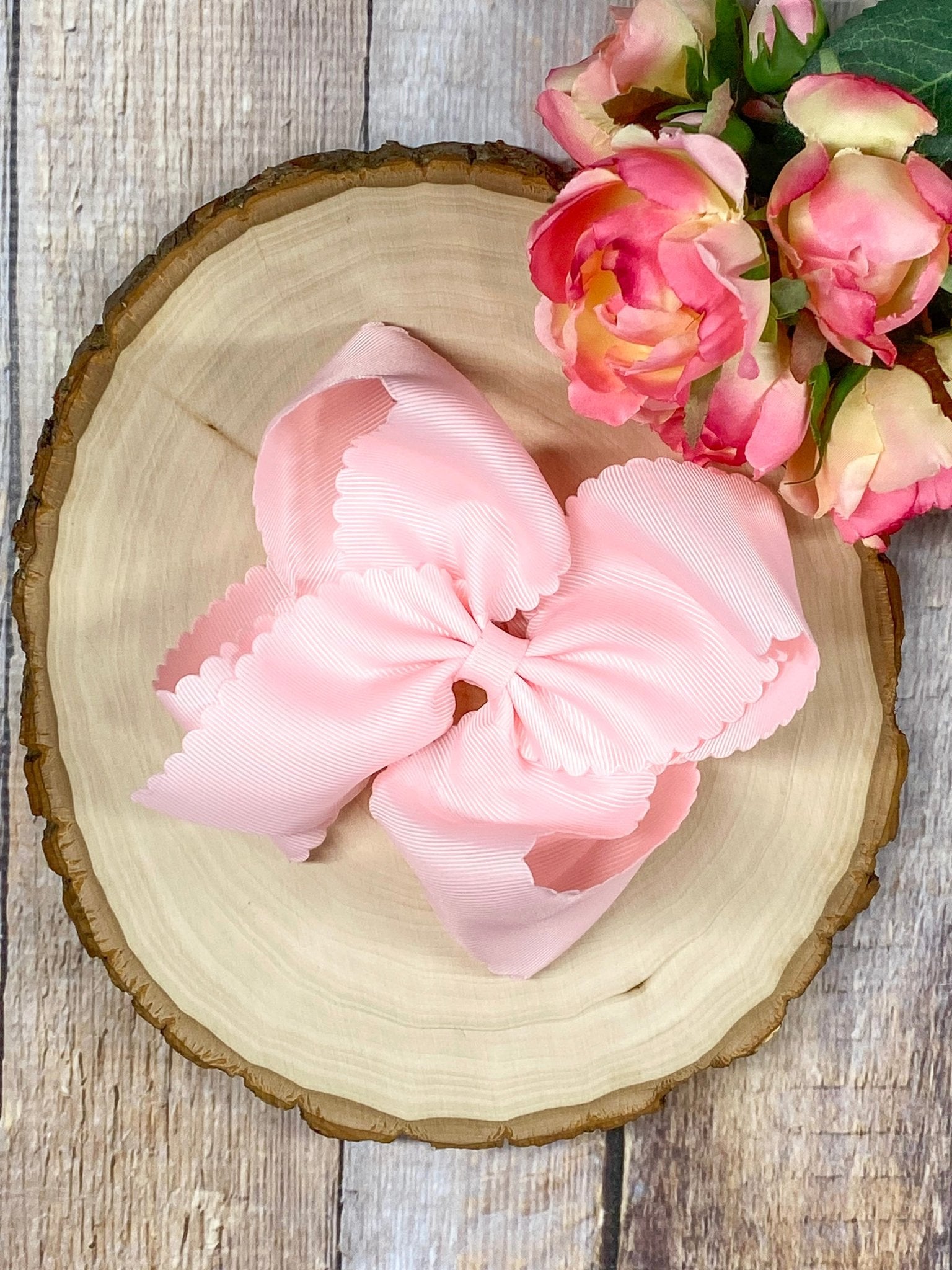 light pink hair bow on wooden display