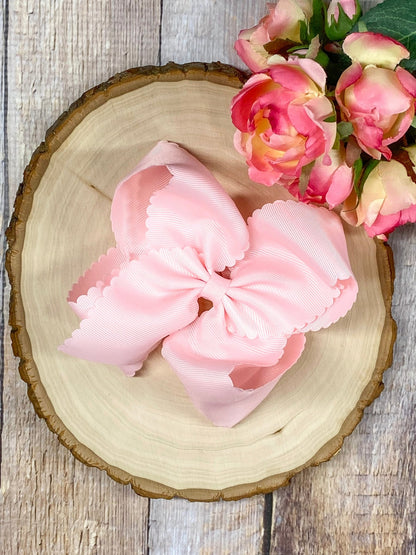 light pink hair bow on wooden display
