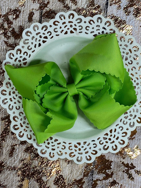 Green bow on a white doily with a textured background
