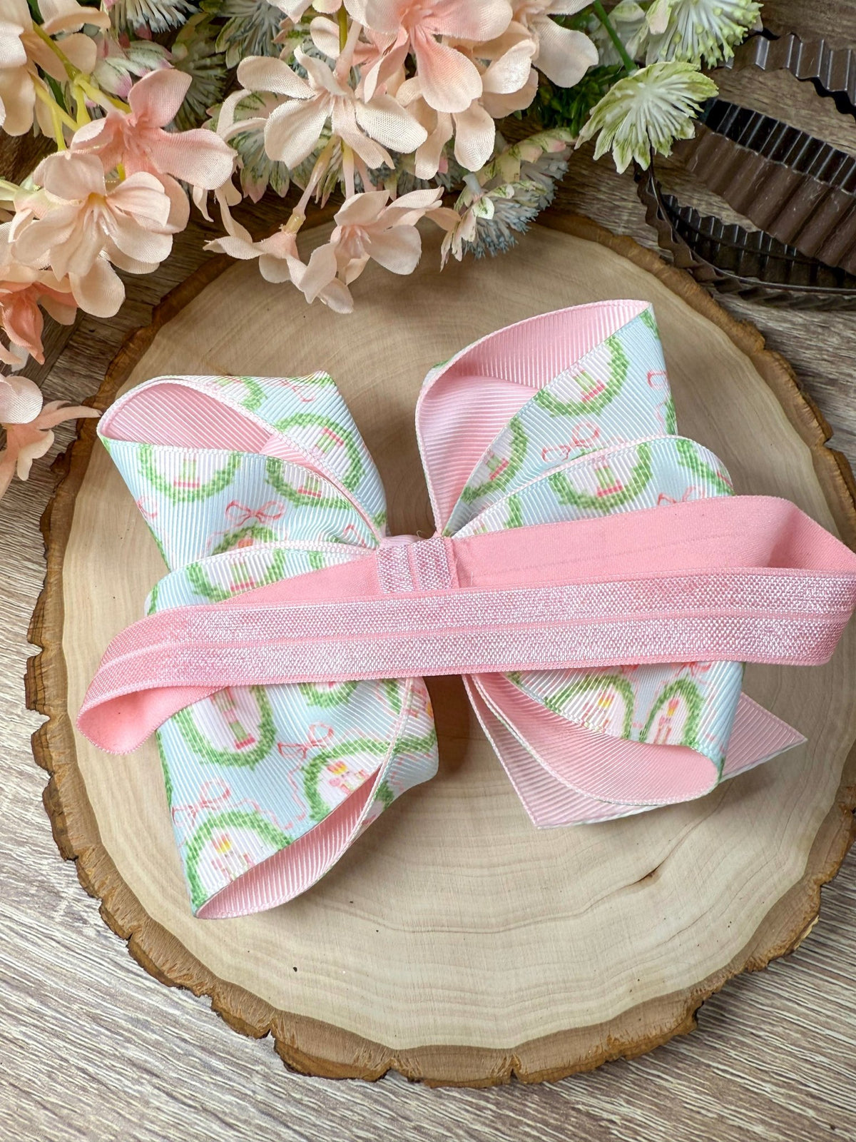 Back of pastel nutcracker bow headband showing satin elastic band