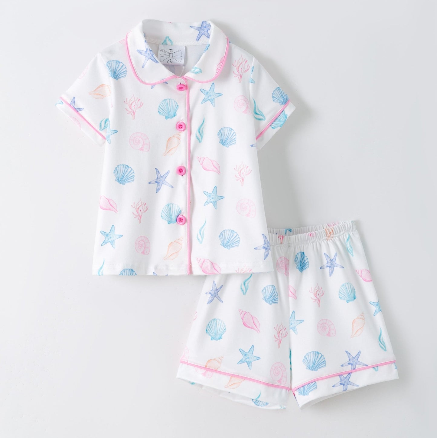 Children's pajama set with shell pattern on a light gray background
