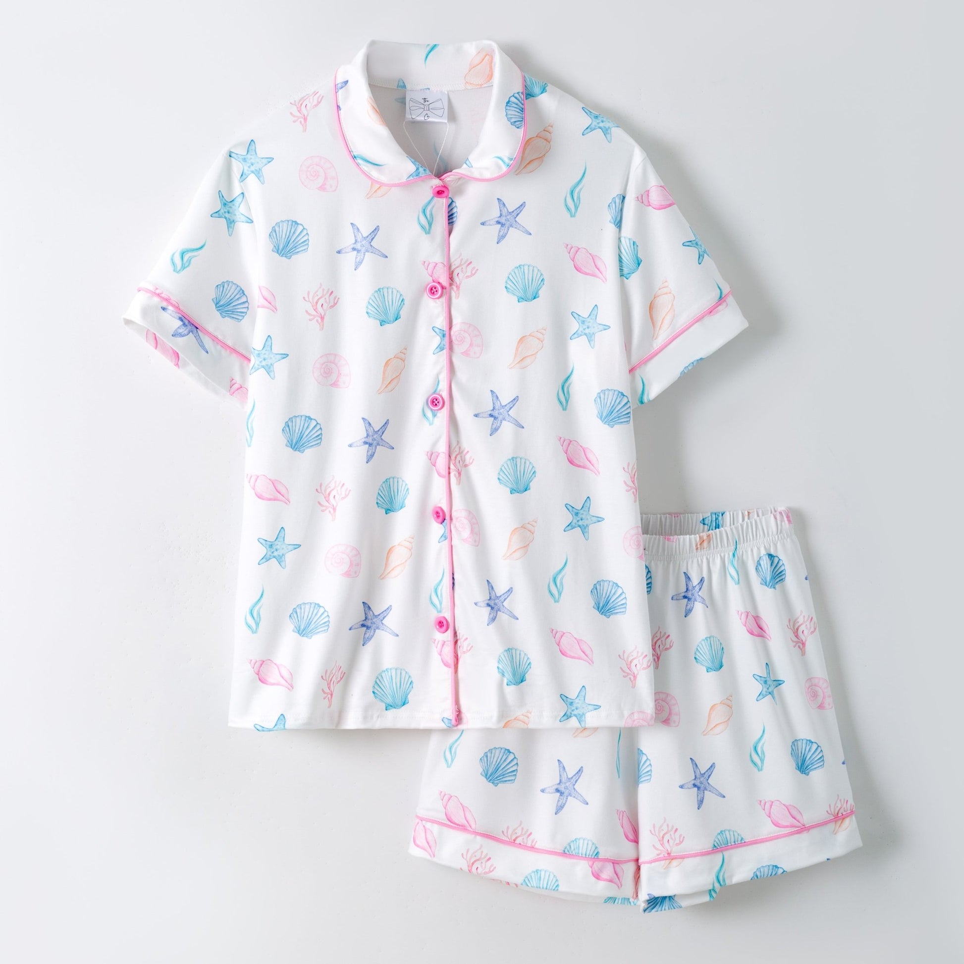 Children's pajama set with sea-themed pattern on a light gray background