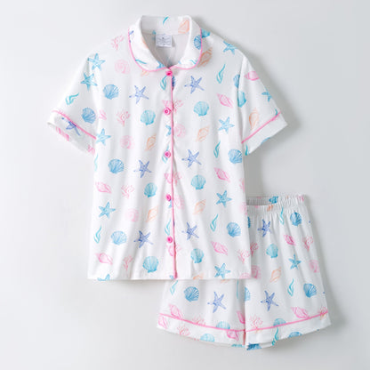 Children's pajama set with sea-themed pattern on a light gray background
