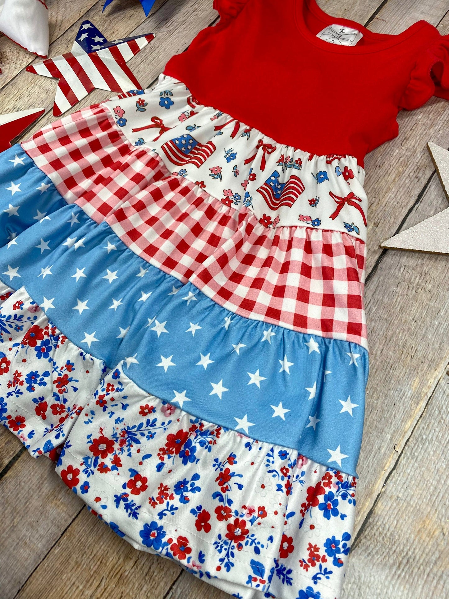 Patchwork Twirl Dress on a wooden background