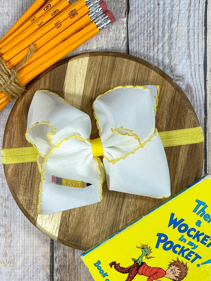 Pencil Embroidered Moonstitch Bow Headband on wooden tray with pencils and yellow book