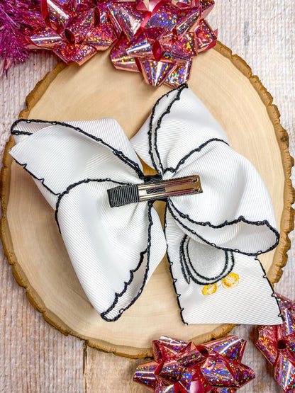 Back of penguin embroidered moonstitch hair bow showing alligator clip