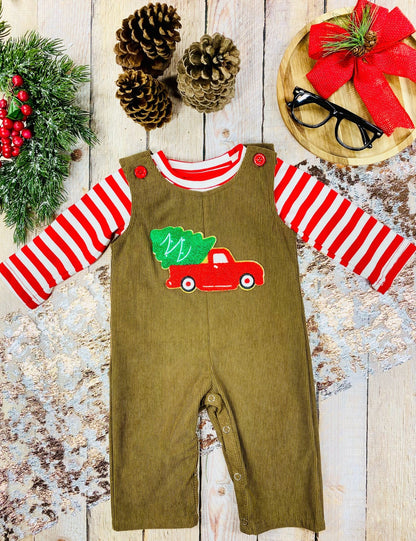 Infant boys’ brown corduroy overalls with red truck and Christmas tree applique, worn over a red-and-white striped shirt.