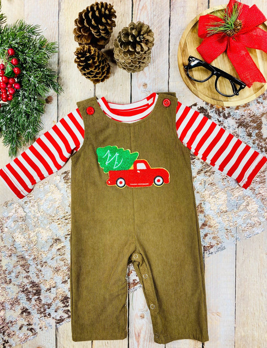 Infant boys’ brown corduroy overalls with red truck and Christmas tree applique, worn over a red-and-white striped shirt.