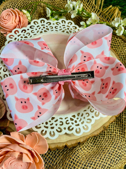 Large pink bow with pig pattern on a decorative surface with flowers