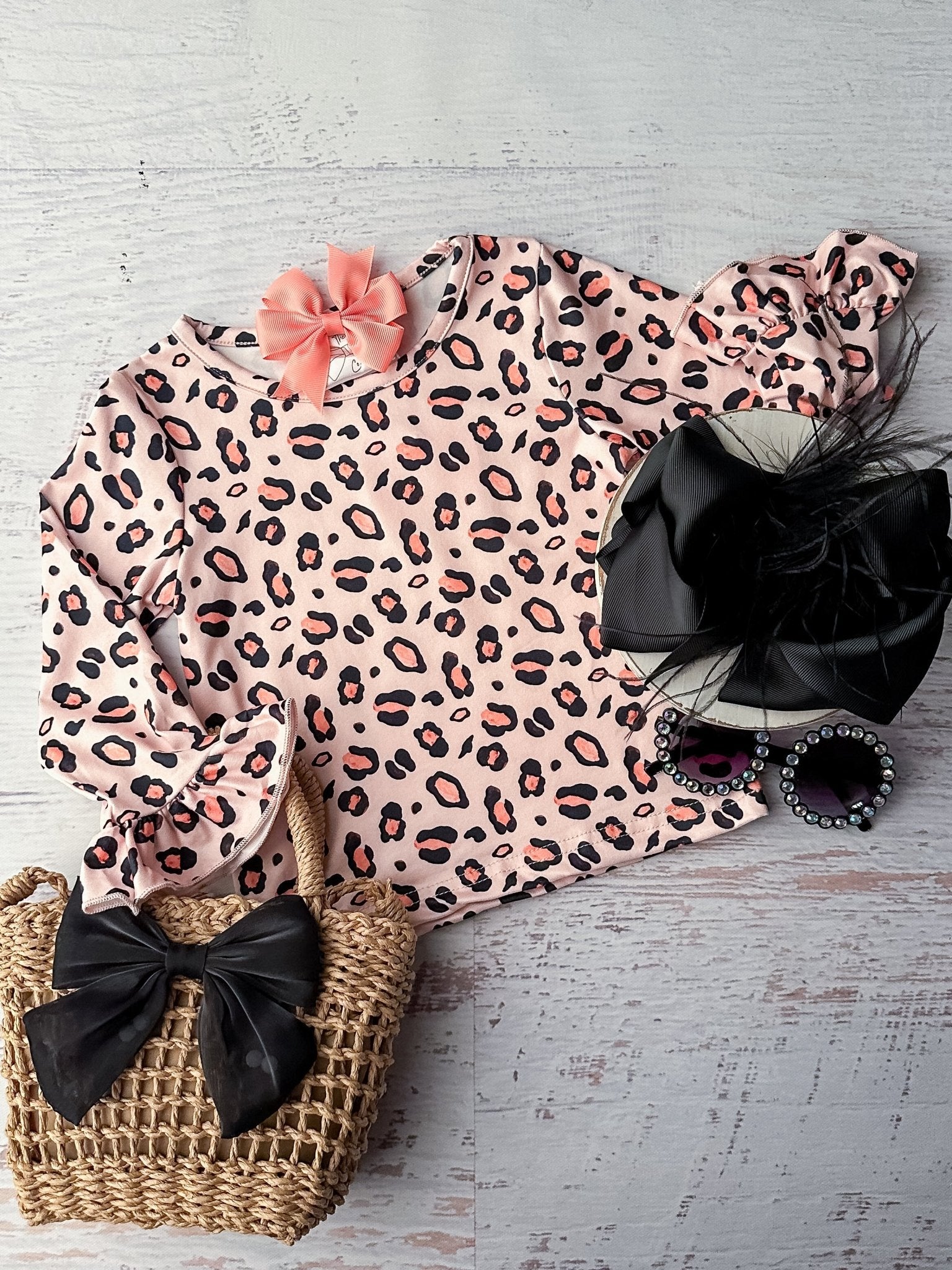 Long sleeve light pink top with black and coral cheetah print all over