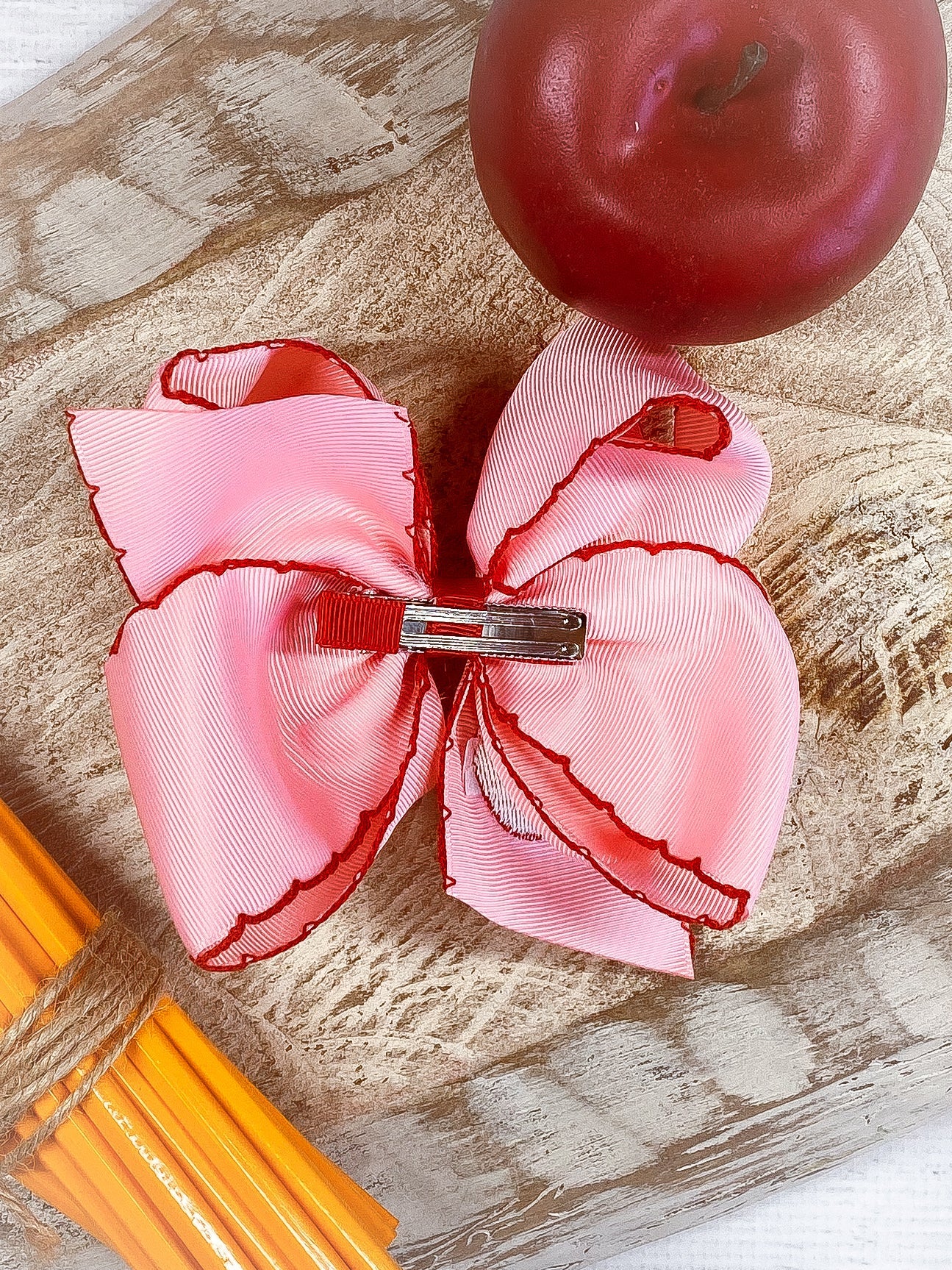 Back of Pink Apple Embroidered Moonstitch Hair Bow showing alligator clip
