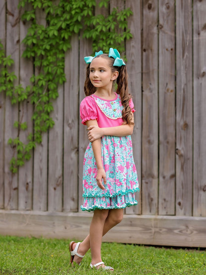 model wearing the Pink & Aqua Floral Ruffle Dress