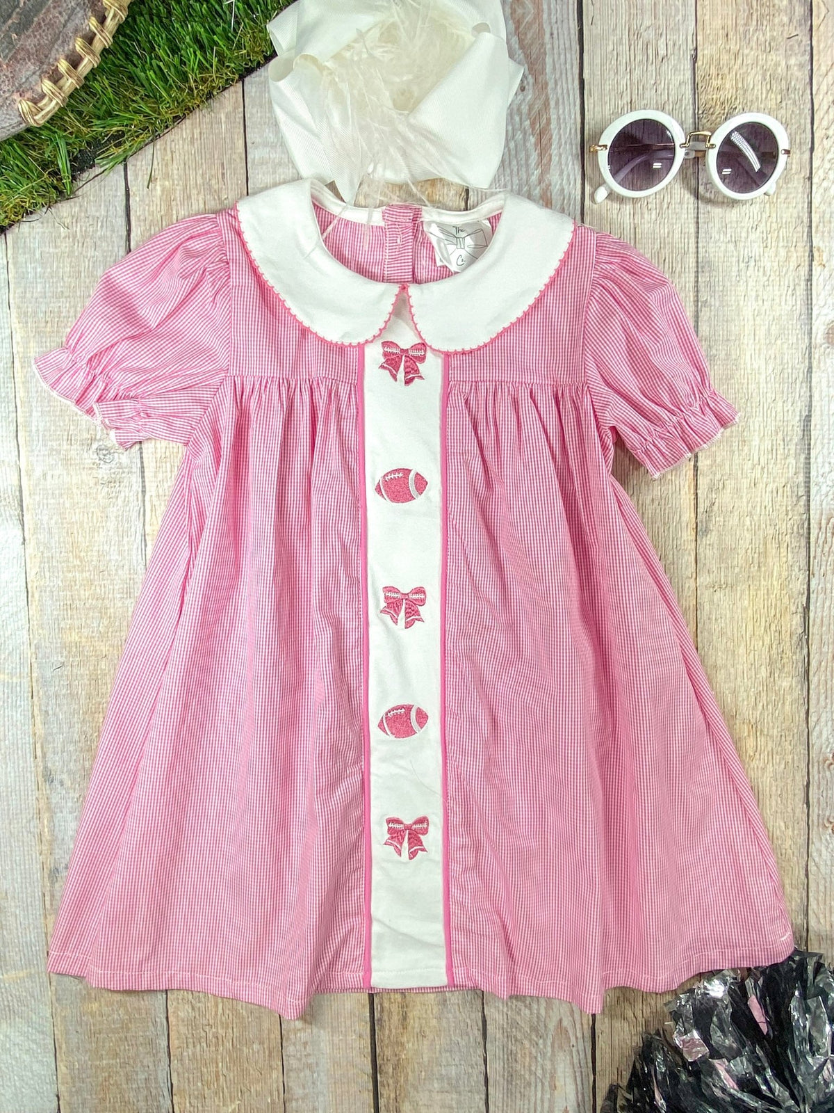Pink dress with bows and footballs down the front