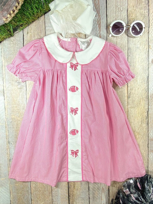 Pink dress with bows and footballs down the front