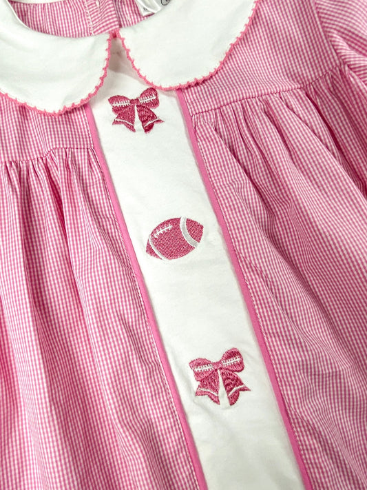 close up of the pink bows and football stitching/embroideries down the center of the dress - Alternative view