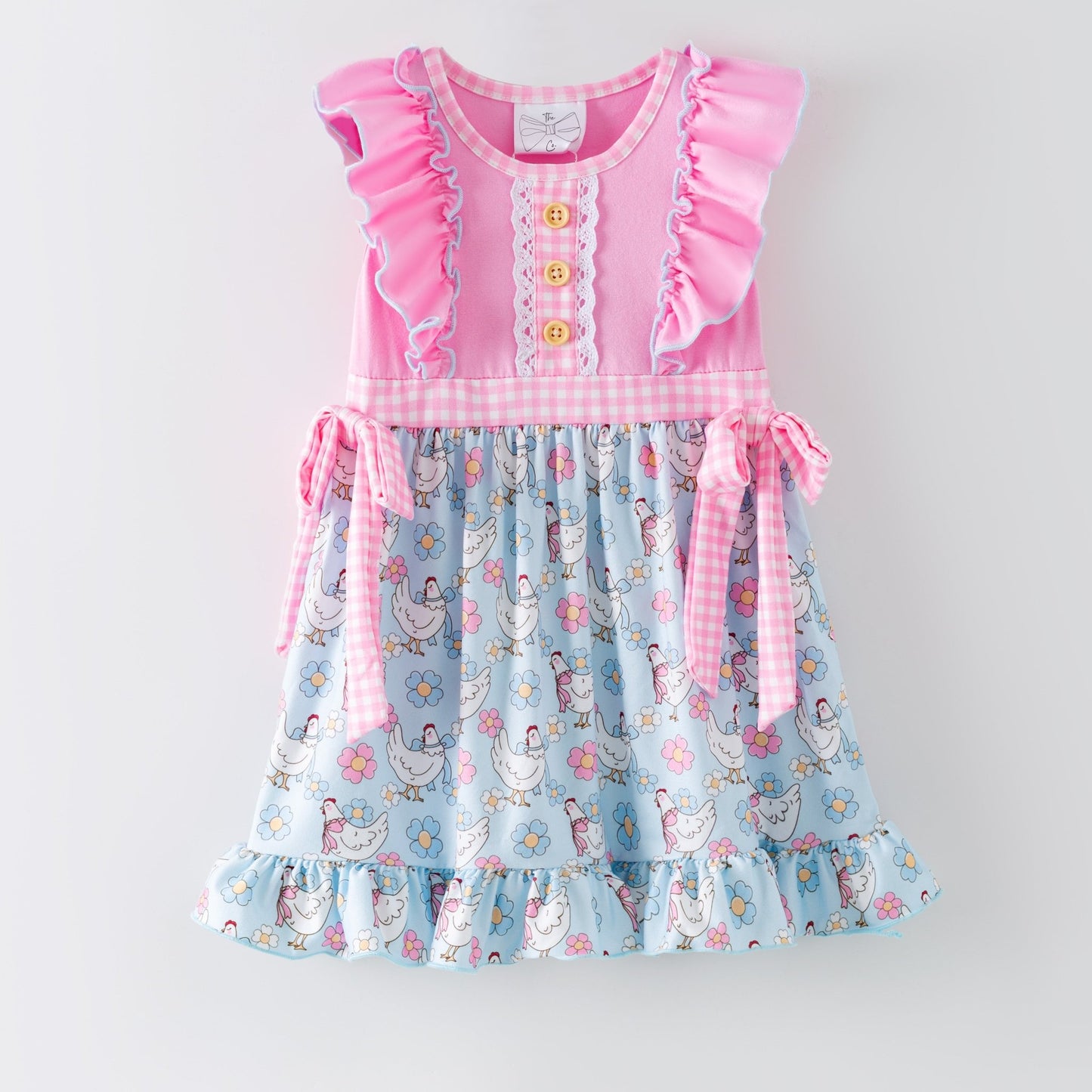 Children's dress featuring chicken pattern on a white background