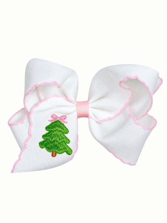 Pink grosgrain hair bow with an embroidered Christmas tree on the tail, on a white background