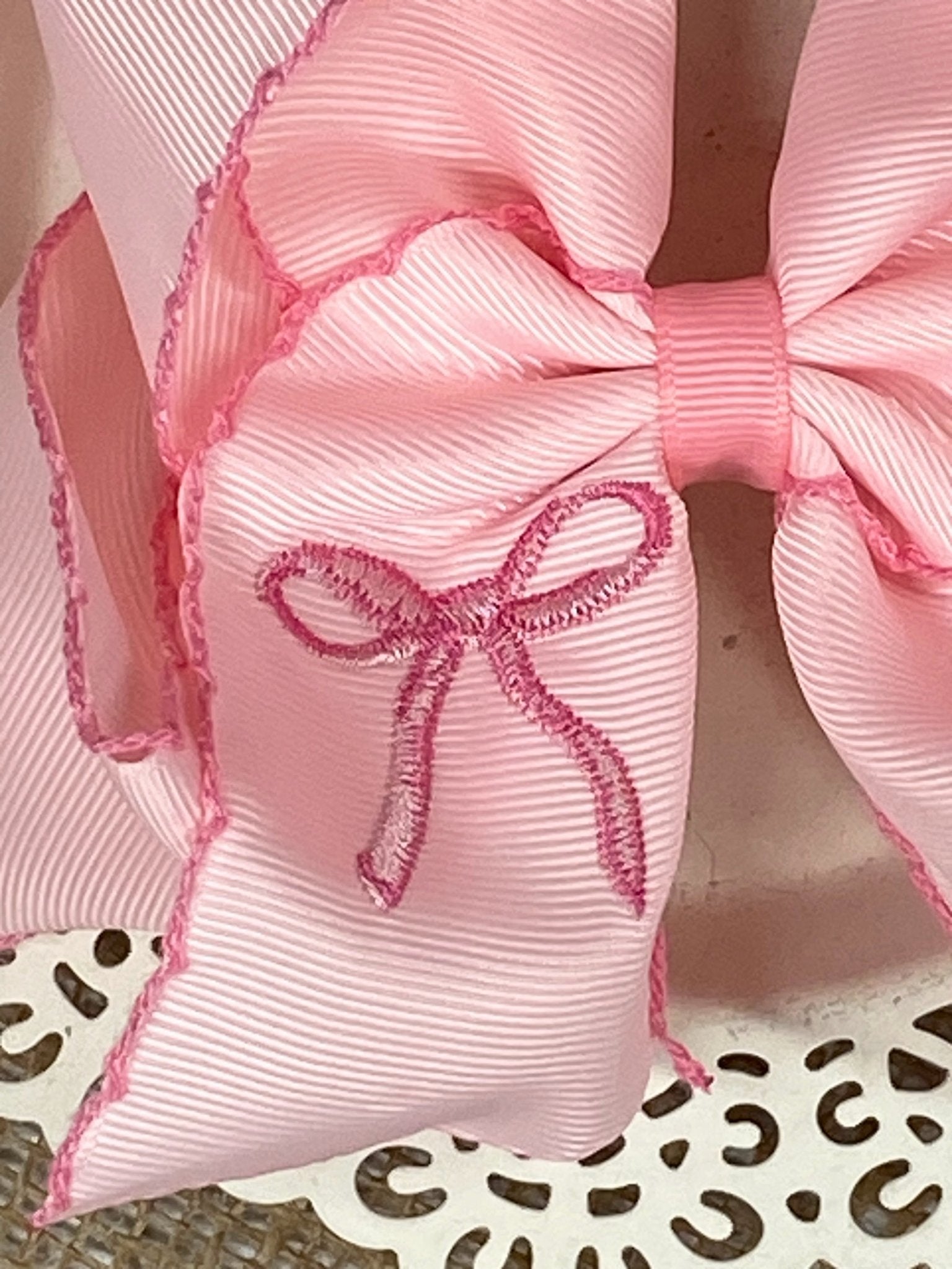 close up of hair bow embroidery 