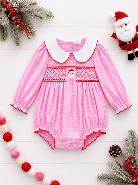 Pink gingham Santa smocked baby Christmas romper flat lay with Peter Pan collar and festive boutique styling.