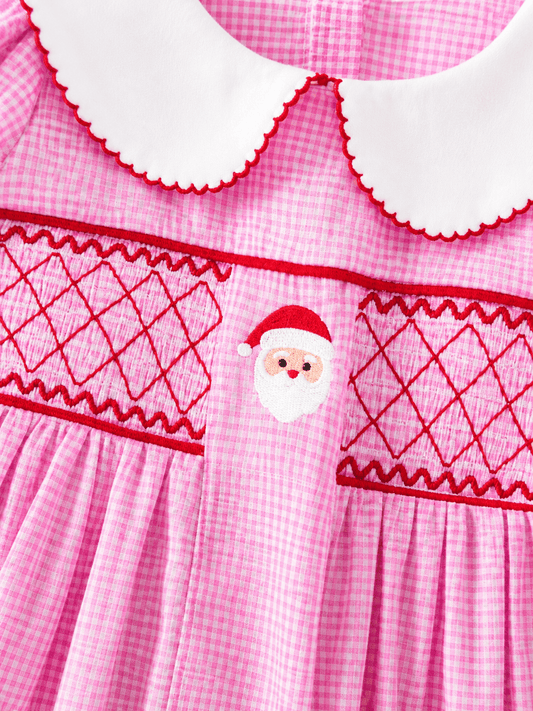 Close-up of Santa embroidery and hand-smocked detail on a pink gingham girls Christmas dress with Peter Pan collar. - Alternative view