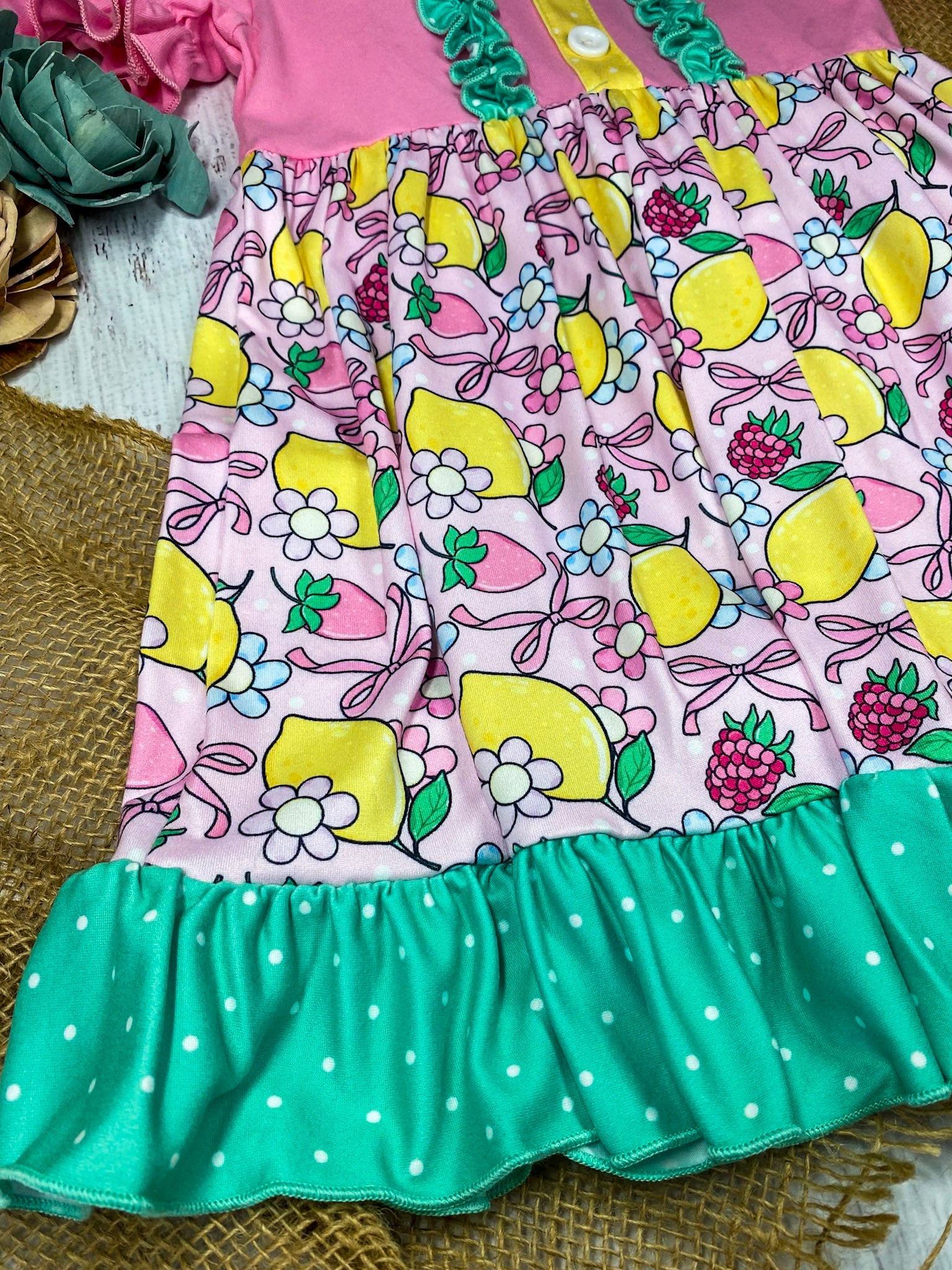 lemon and bows children's dress on a white marble background