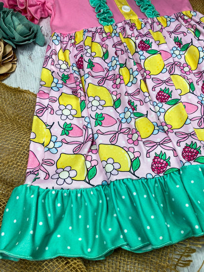 lemon and bows children's dress on a white marble background