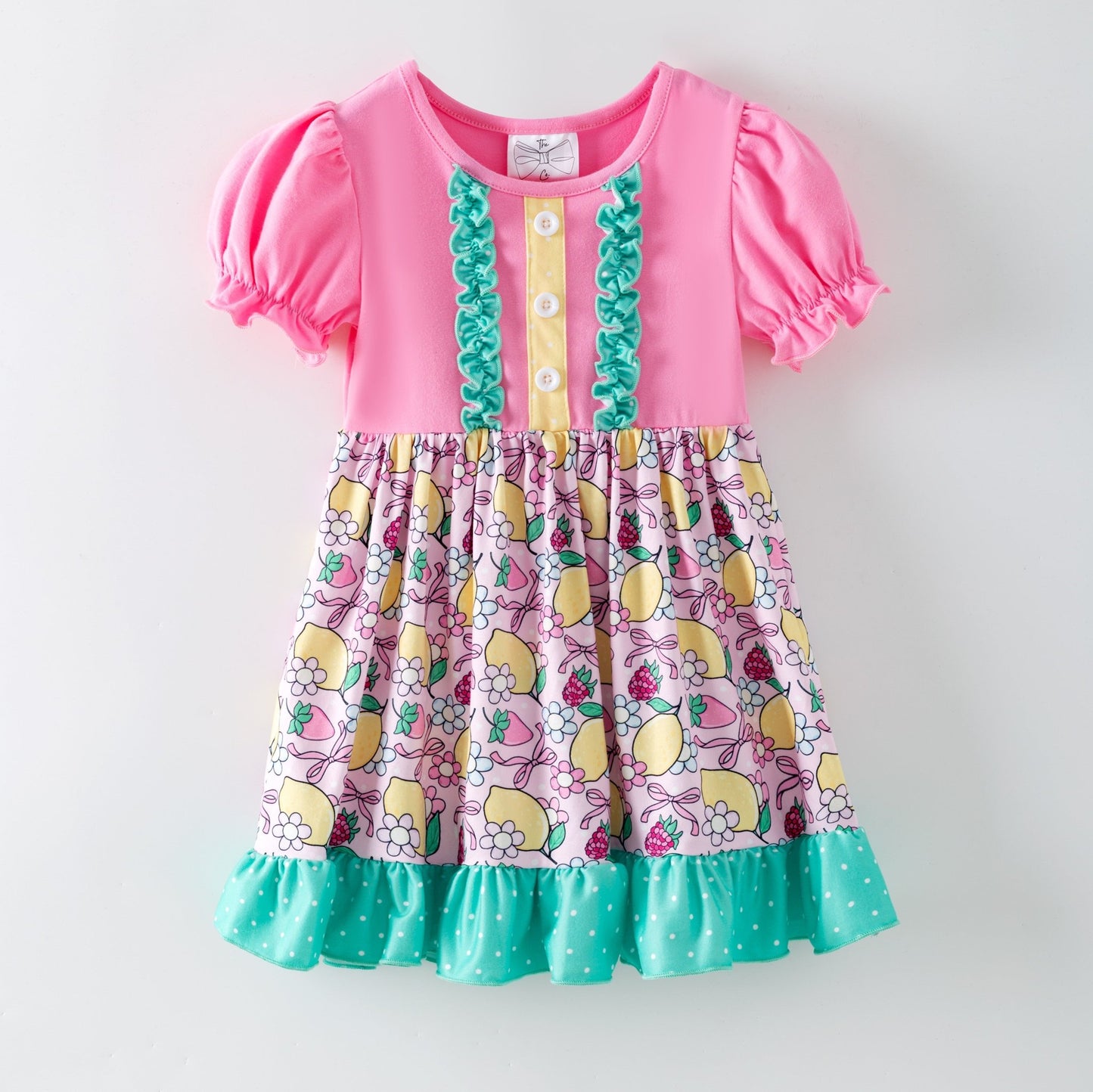 lemon and bows children's dress on a white background