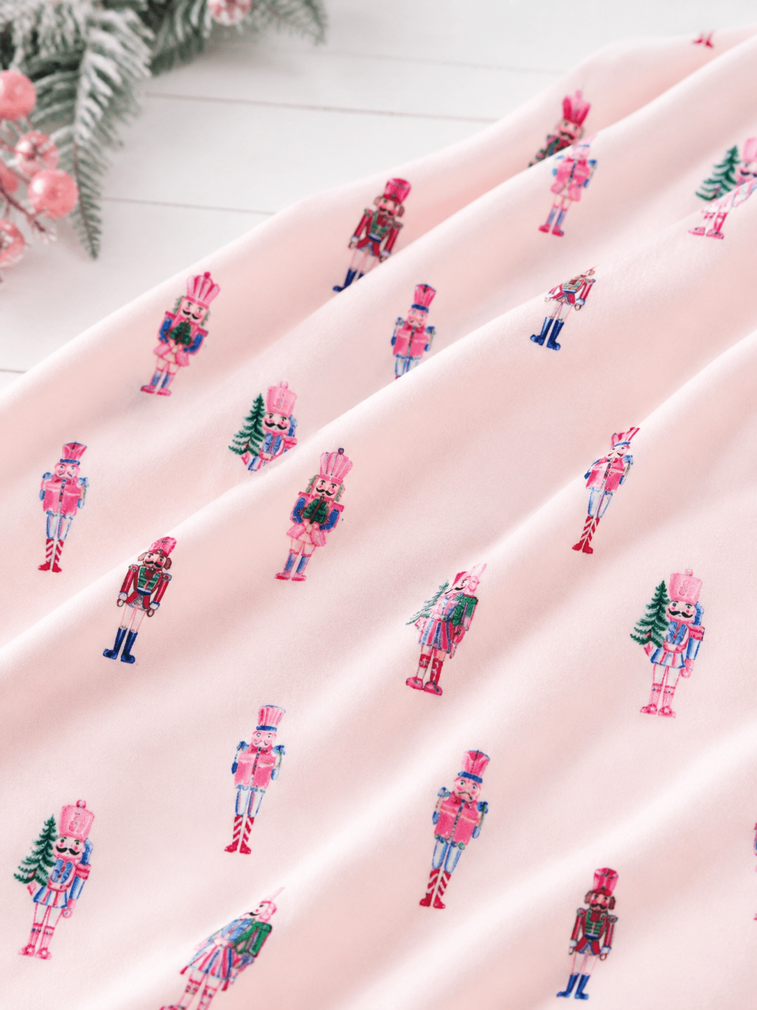 Close-up of Pink Nutcracker Christmas minky baby blanket with pastel nutcracker print and silky soft plush fabric.
