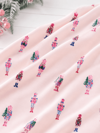 Close-up of Pink Nutcracker Christmas minky baby blanket with pastel nutcracker print and silky soft plush fabric.