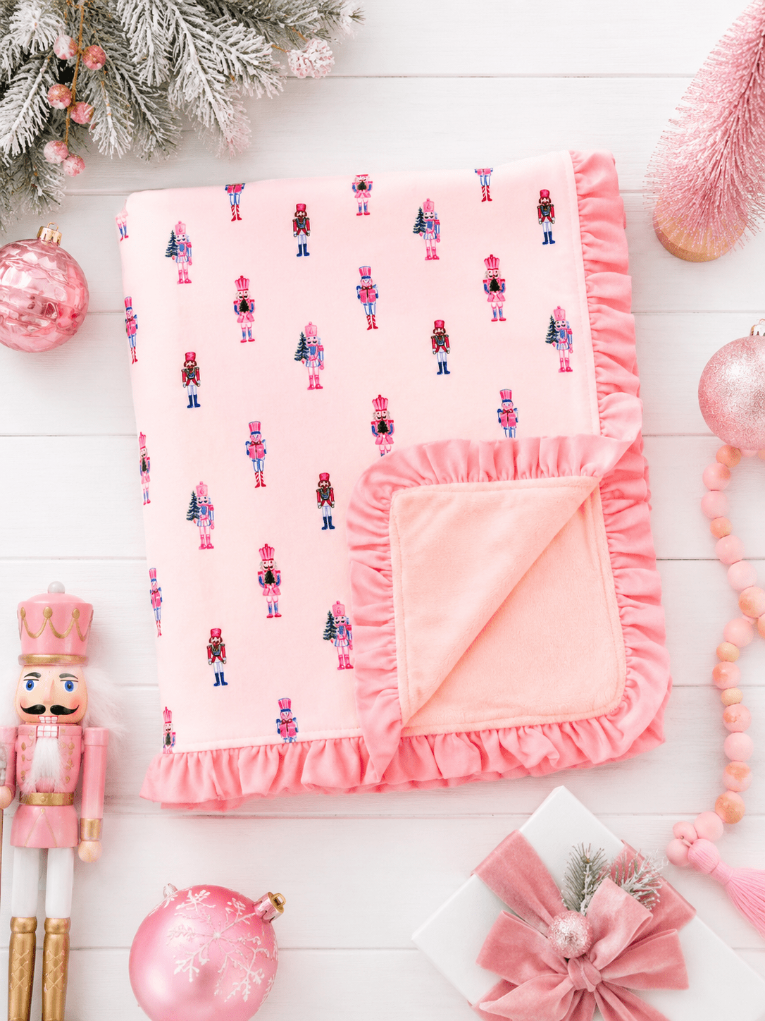 Pink Nutcracker Christmas ruffle minky baby blanket with plush blush backing and elegant ruffle trim detail.